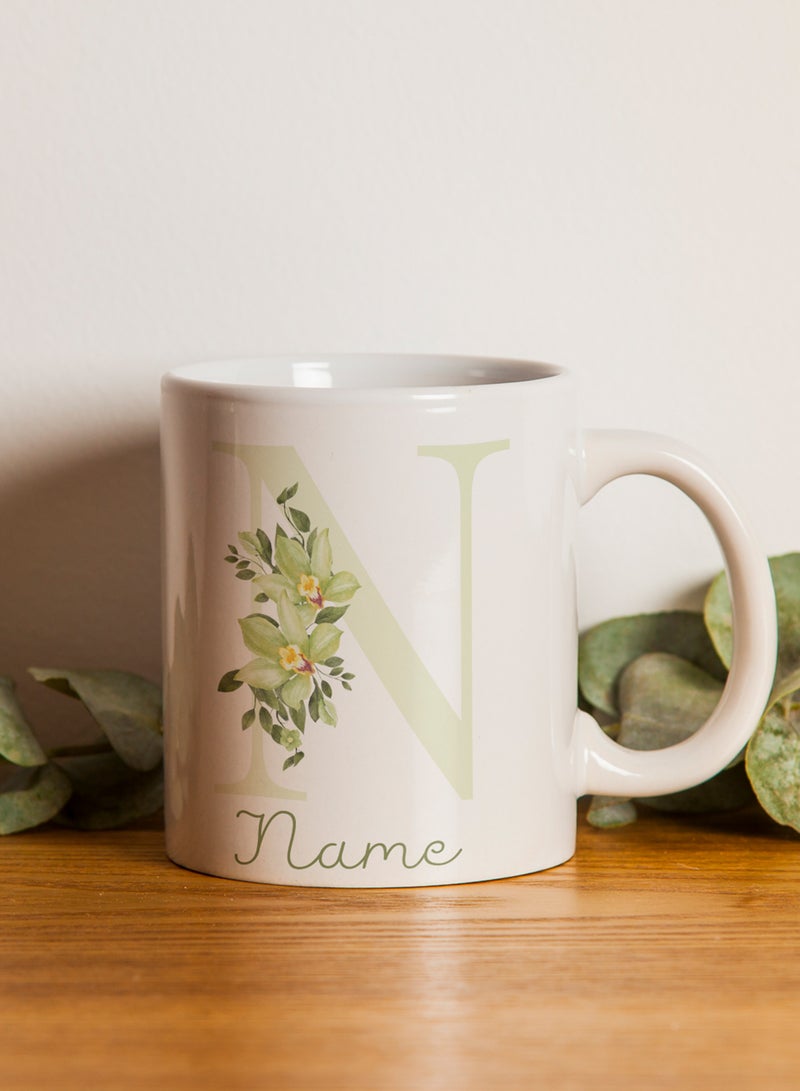 LOWHA - Customizable Ceramic 11 oz Mug with Personalized Name and Green Flowers on First Letter of The Name White - Image 1