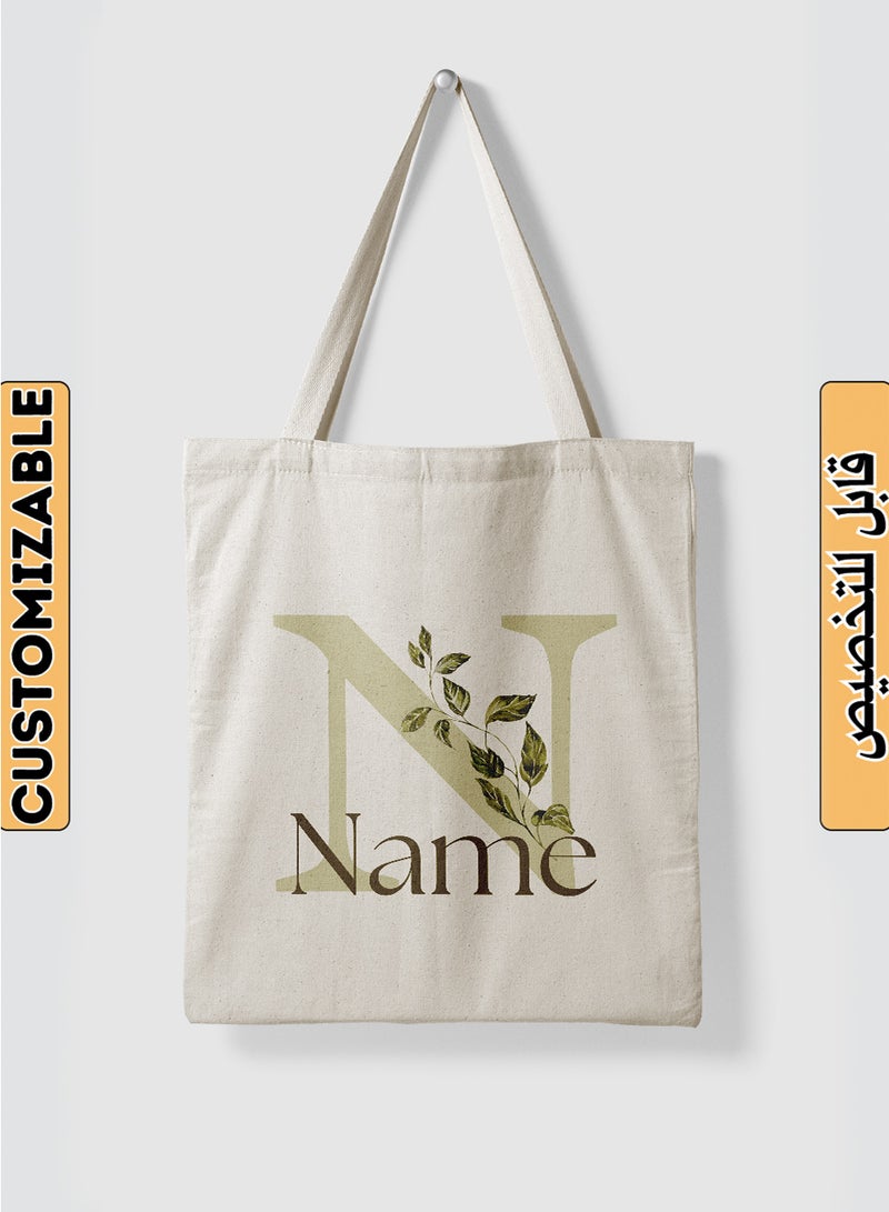 لوحة حقيبة يد بأحزمة كتف من البوليستر باسم قابل للتخصيص بتصميم حرف الاسم الأول مُزَيَّن بأوراق نباتية بيج - Image 1