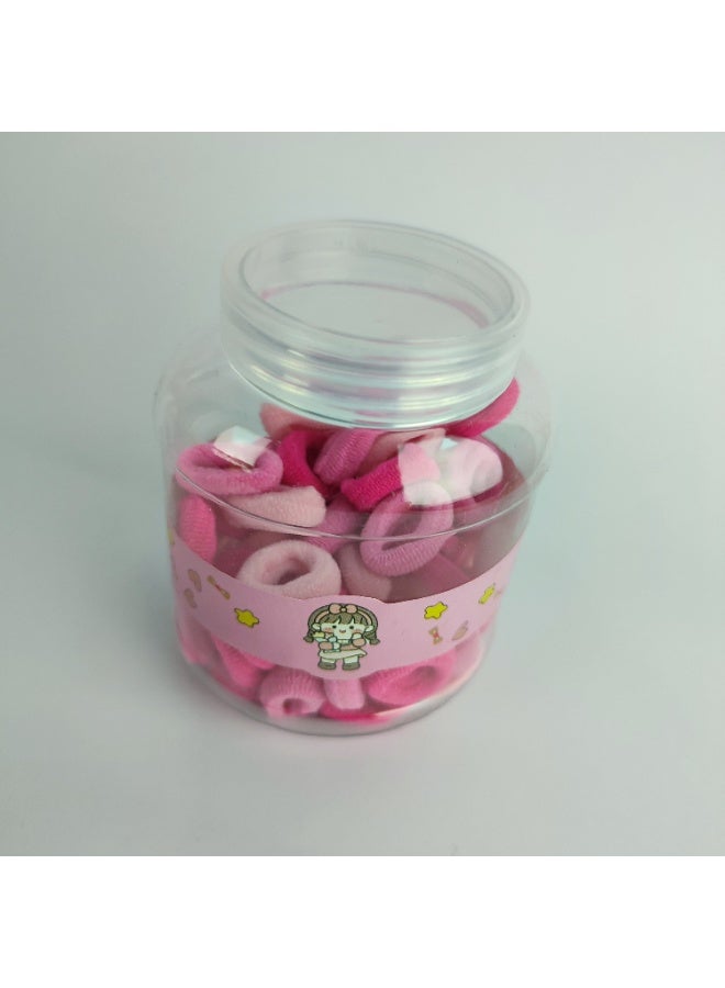A plastic jar containing small elastic hair clips - Image 2