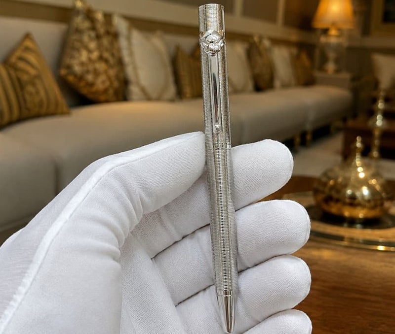 A ballpoint pen adorned with a panther (tiger) tip.