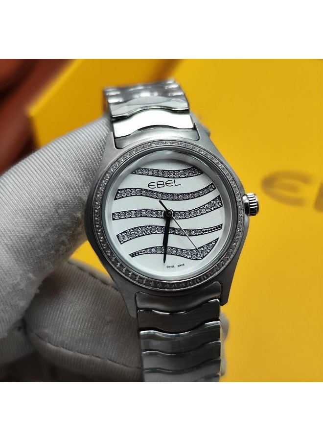 The Ebel women's watch features a classic design with a distinctive wave-shaped strap.