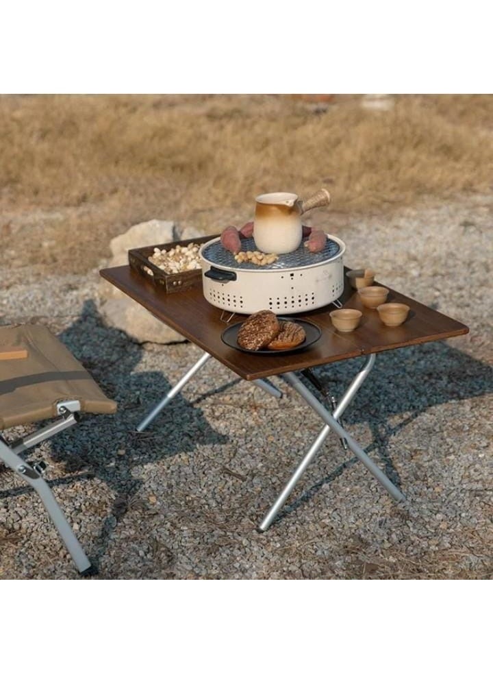 A round charcoal grill featuring foldable legs for easy storage and portability. It consists of a perforated charcoal bowl, a stainless steel grilling grate, and a pair of tongs, making it ideal for both trips and home use. - Image 1