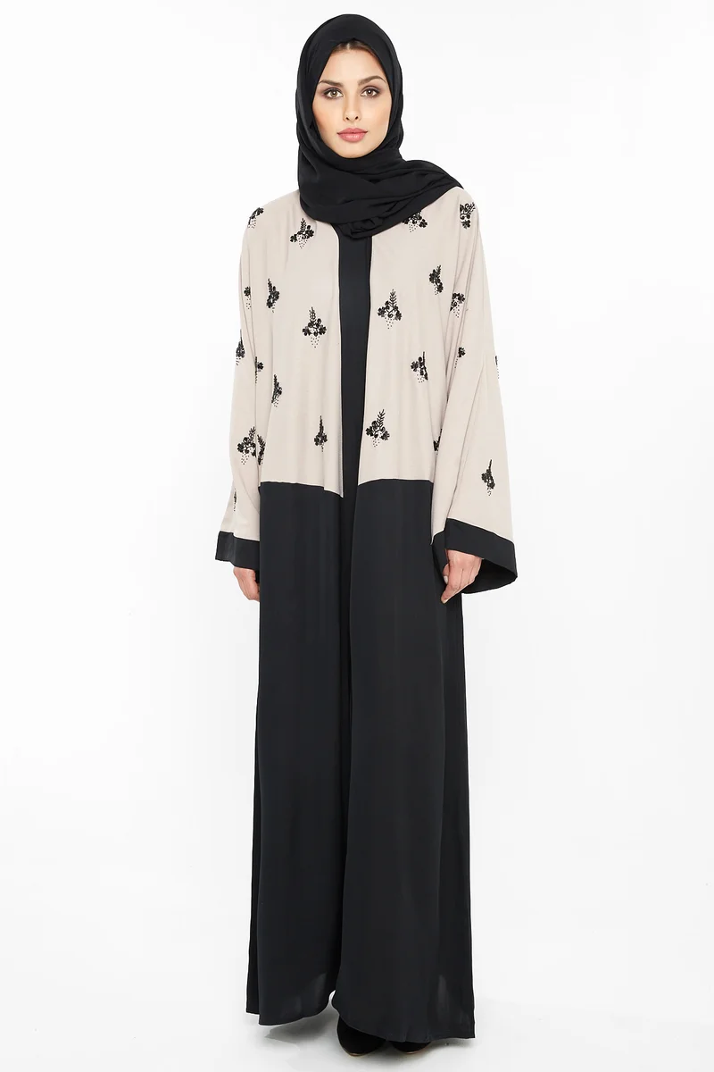 NUKHBAA A casual abaya in cream with black floral embroidery detail-Aj397A