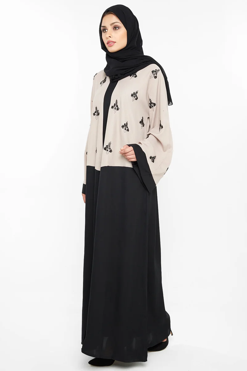 NUKHBAA A casual abaya in cream with black floral embroidery detail-Aj397A