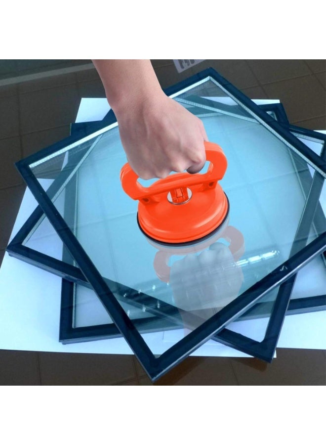 A large tool for repairing car dents, equipped with a suction cup, lever, and handle, for paintless dent removal. Suitable for car body panels, glass, mirrors, granite, and tiles. It features a strong grip and is a durable, portable hand tool (orange). - Image 1