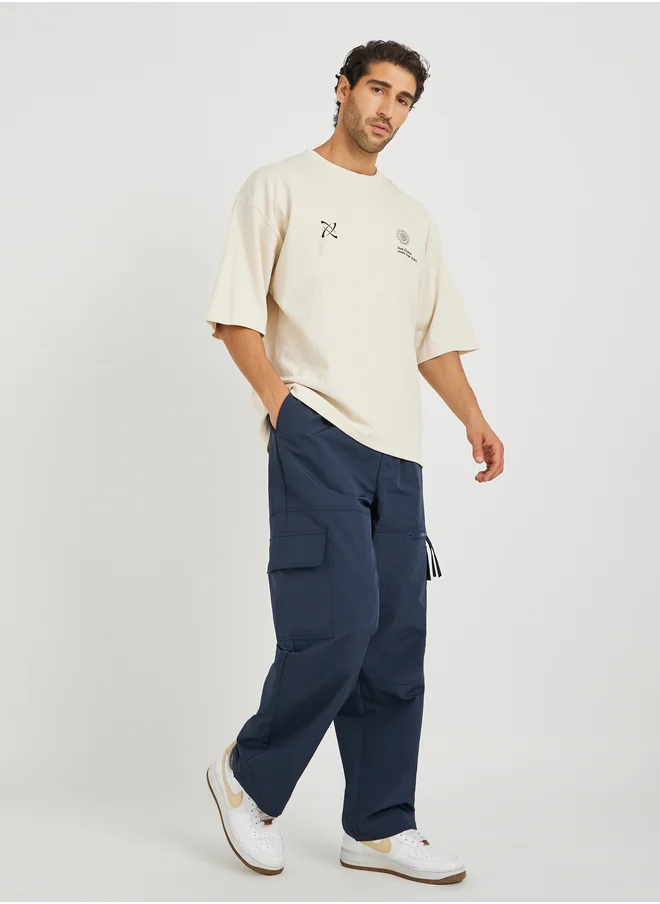 ستايلي Styli Men Navy Blue Solid Oversized Open Hem Cargo Joggers with Zipper Pockets