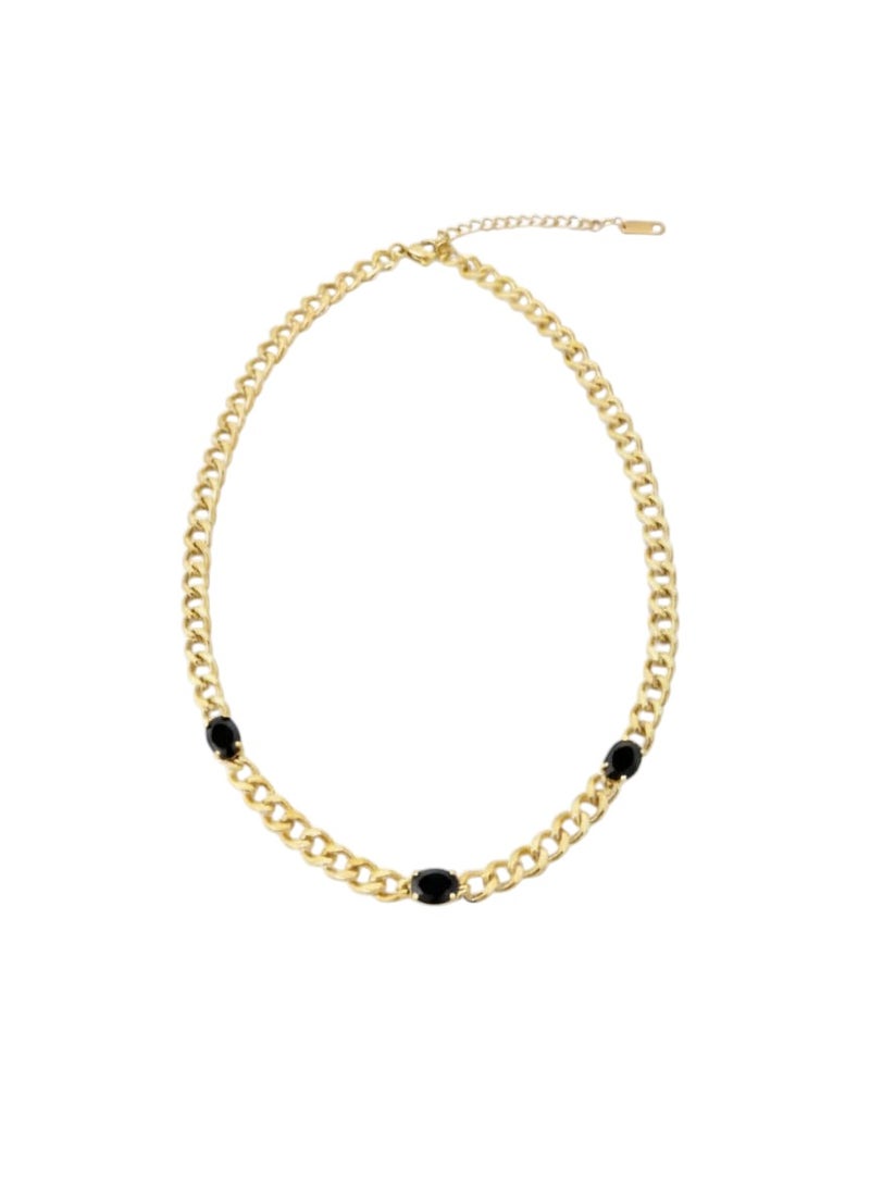 An elegant gold necklace with a distinctive thick chain, adorned with three oval-shaped black stones. Made of rust-resistant stainless steel with an adjustable clasp. - Image 1