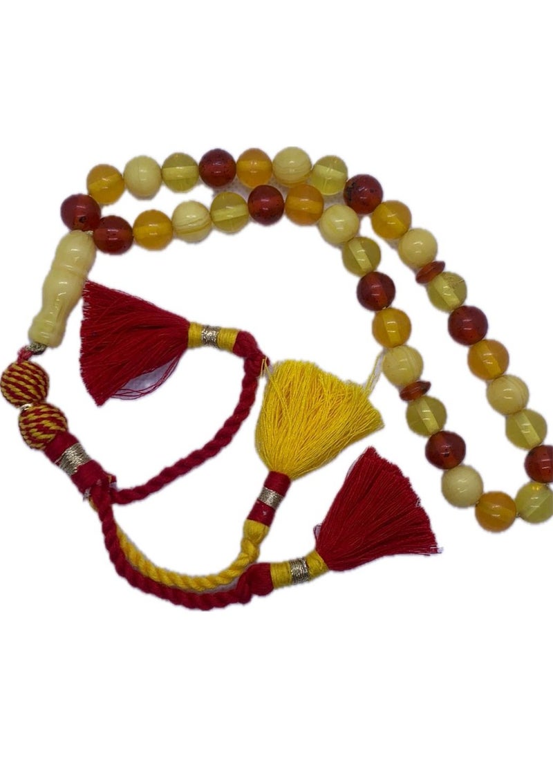Generic - Amber Soil Rosary    Features wonderful colors and a distinctive handmade block (tassel) made of fabric  The rosary is considered one of the beautiful and distinctive pieces in the world of rosaries. It is a type of rosary that is made using grains of soil or amber powder, which is a type of fossilized organic rock, and is considered one of the materials that were used in making jewelry and decorative objects throughout the ages. - Image 1