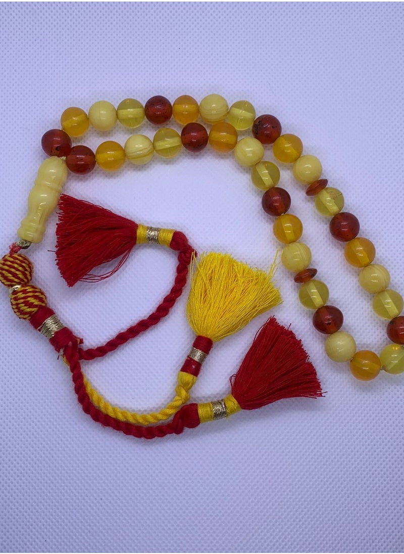 Generic - Amber Soil Rosary    Features wonderful colors and a distinctive handmade block (tassel) made of fabric  The rosary is considered one of the beautiful and distinctive pieces in the world of rosaries. It is a type of rosary that is made using grains of soil or amber powder, which is a type of fossilized organic rock, and is considered one of the materials that were used in making jewelry and decorative objects throughout the ages. - Image 1