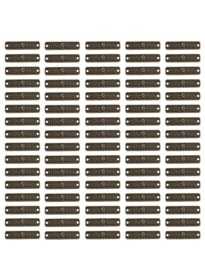 Micro Traders 150 قطعة علامات معدنية مصنوعة يدويًا مع ثقبين ملحقات ديي للجينز والحقائب والأحذية والقبعات وصنع المجوهرات والحرف اليدوية هدايا 25X6 مم مستطيل برونزي - Image 1