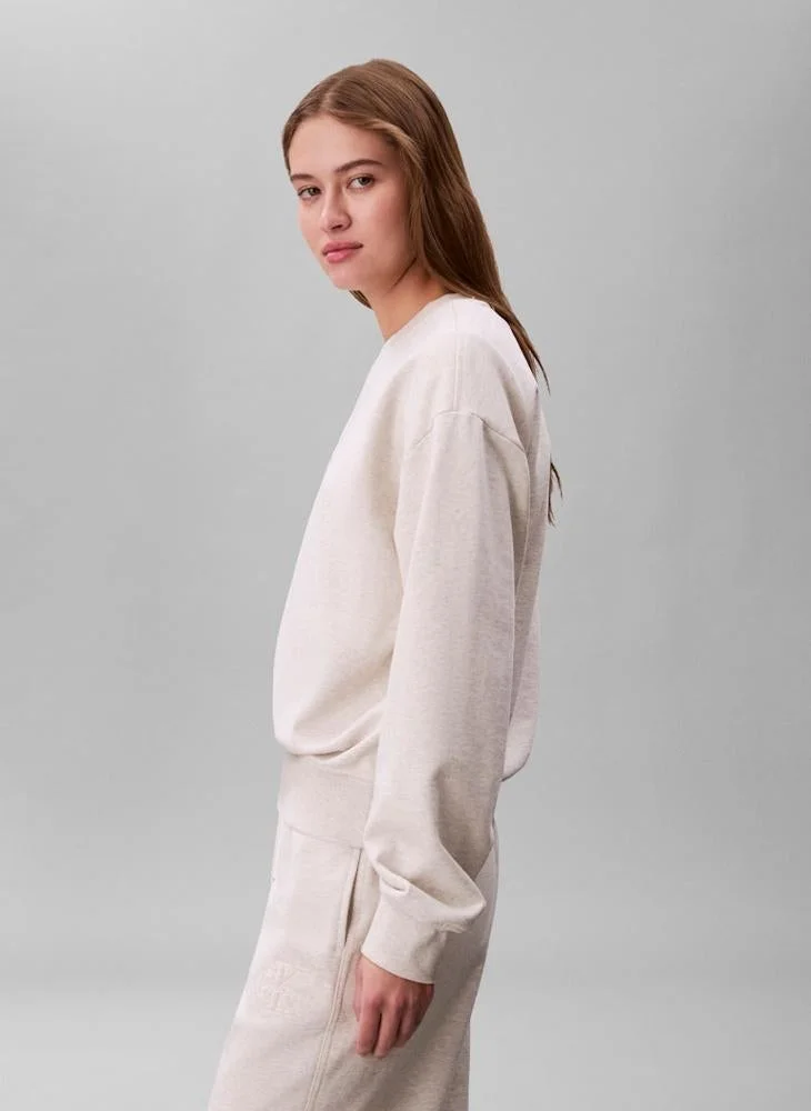 Calvin Klein Jeans Vanilla Heather Embossed Logo Terry Crew Neck Sweatshirt for Women | Best Price UAE
