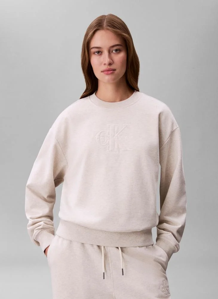 Calvin Klein Jeans Vanilla Heather Embossed Logo Terry Crew Neck Sweatshirt for Women | Best Price UAE