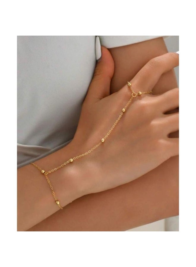 Bracelets A stunning gold-tone hand chain that seamlessly connects a delicate ring to a graceful bracelet - Image 1