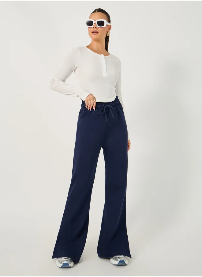 Styli Solid Drawstring Waist Flared Joggers with Side Slit
