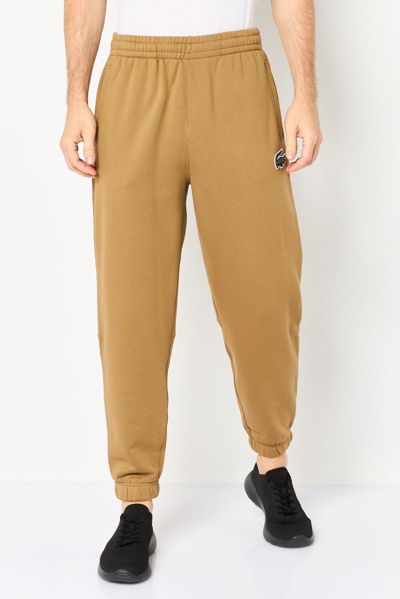 LACOSTE Men Relaxed Fit Embroidered Logo Sweatpants, Tan - Image 1