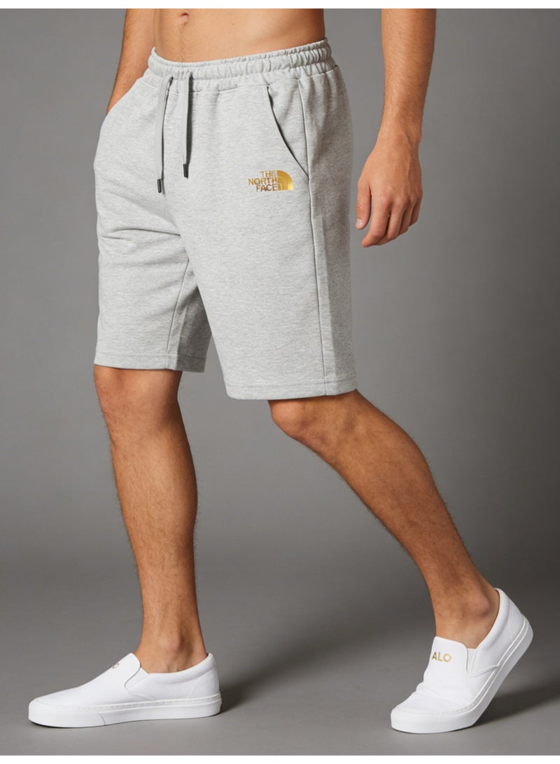 ذا نورث فيس THE NORTH FACE men's grey shorts with gold logo, loose drawstring knit and knee sweatpants. - Image 1