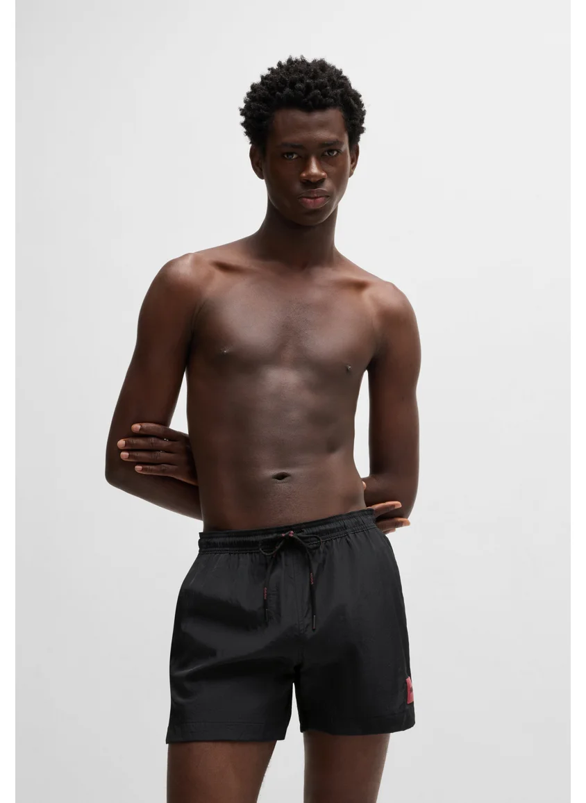 هوجو Fully lined swim shorts with red logo label