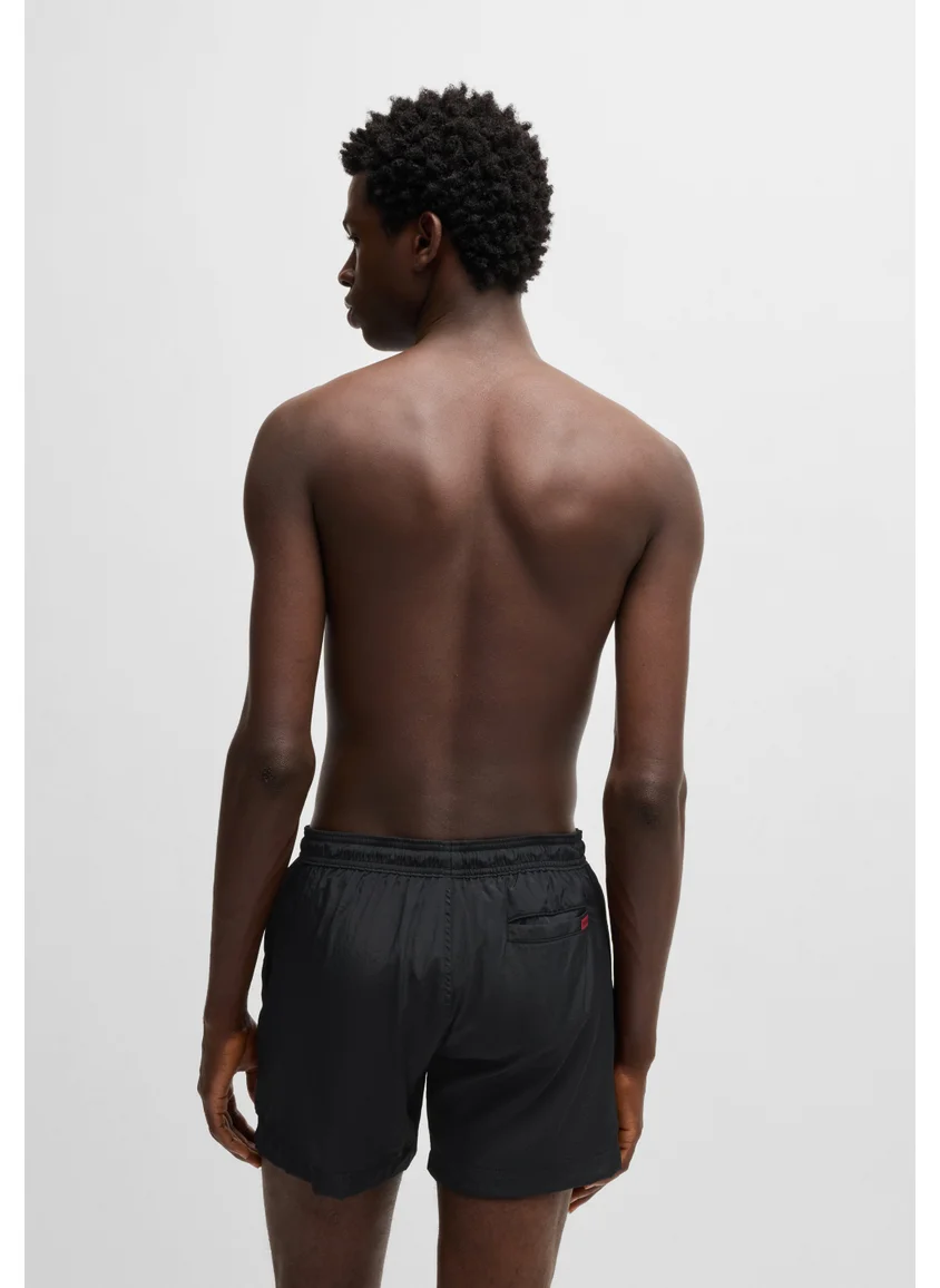 هوجو Fully lined swim shorts with red logo label