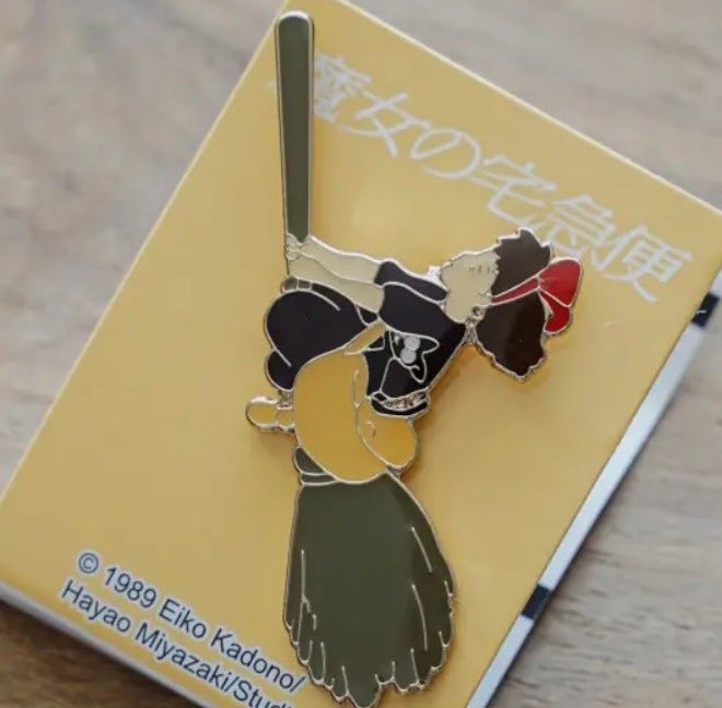 Pins Kiki on her broom - Kiki's Delivery Service