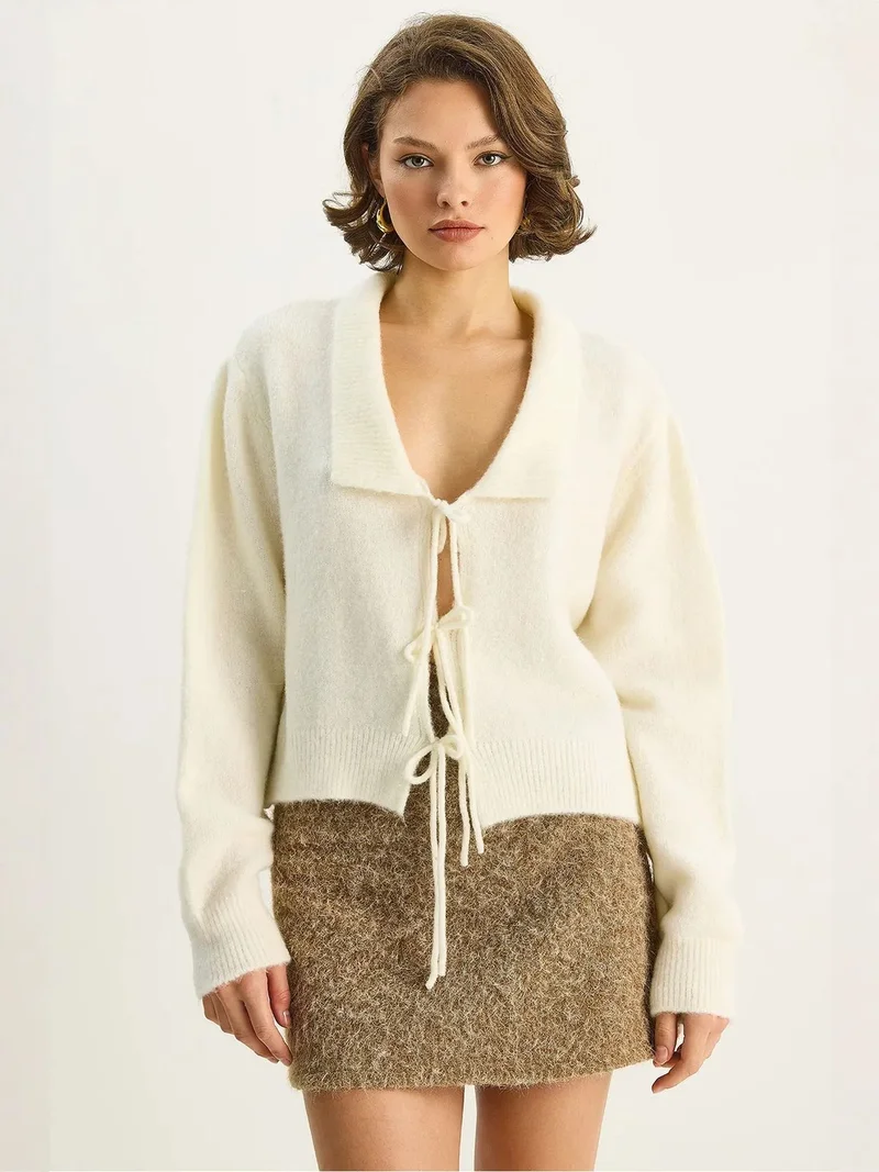 بيانكو لوتشي LUCCI Oversized V-Neck Tie Closure Ribbed Cardigan