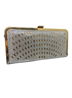 A luxurious women's bracelet bag, gold and silver, decorated with a golden metal arm