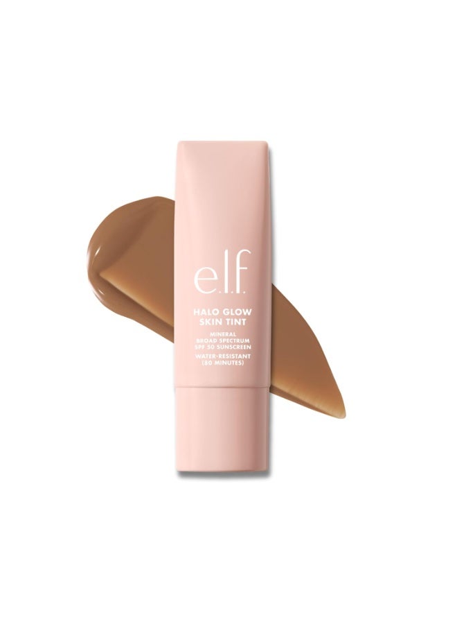 إلف e.l.f. Halo Glow Skin Tint SPF 50، مرطب ملون لتغطية خفيفة وقابلة للبناء، يمنح البشرة إشراقة طبيعية، نباتي ولم يُختبر على الحيوانات، درجة 12 Tan Cool، سعة 30 مل. - Image 1