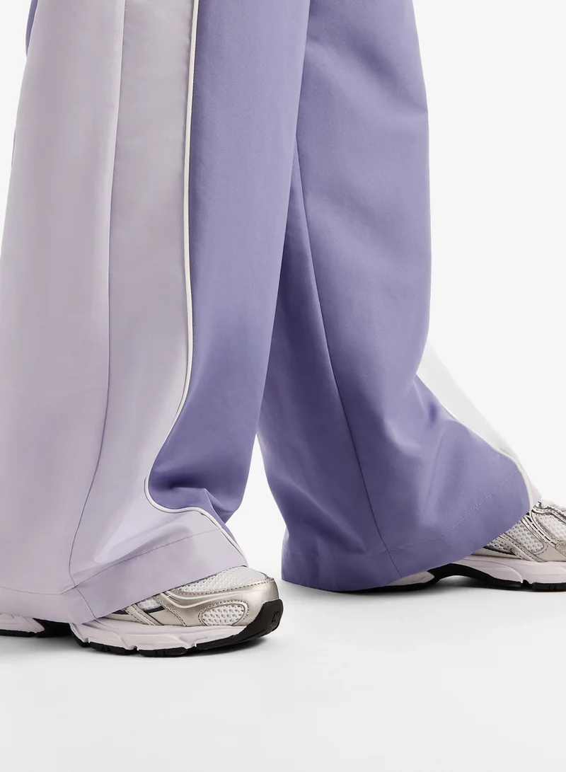 New Balance DARK SMOKED VIOLET (DSV) Trackside Woven Sweatpants for Women | Best Price UAE