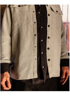 button-up jacket with woven pattern and pockets
