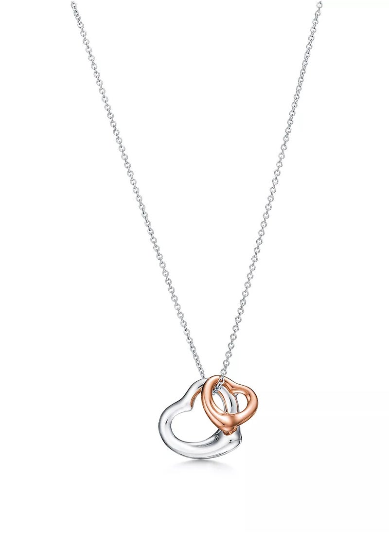 Elsa Peretti® Open Heart pendant in sterling silver and 18k rose gold.