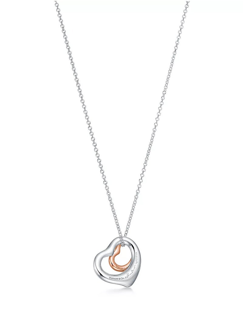 Elsa Peretti® Open Heart pendant in sterling silver and 18k rose gold.