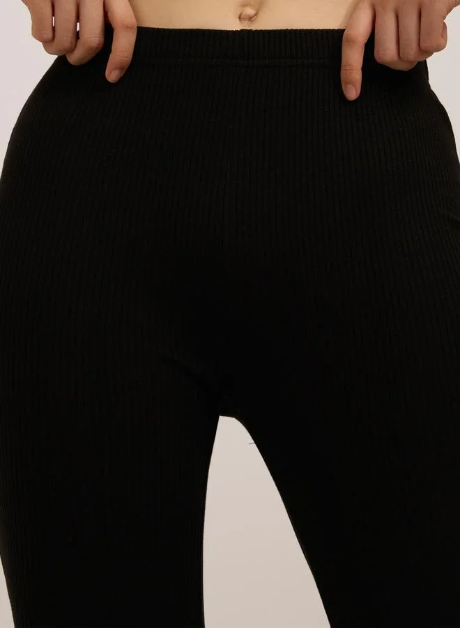Outzidr  Black Ribbed Basic Flared Leggings for Women | Best Price UAE