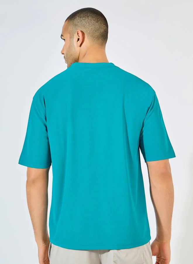 Styli Micro Pique Knit Oversized T-Shirt with Reflective Logo