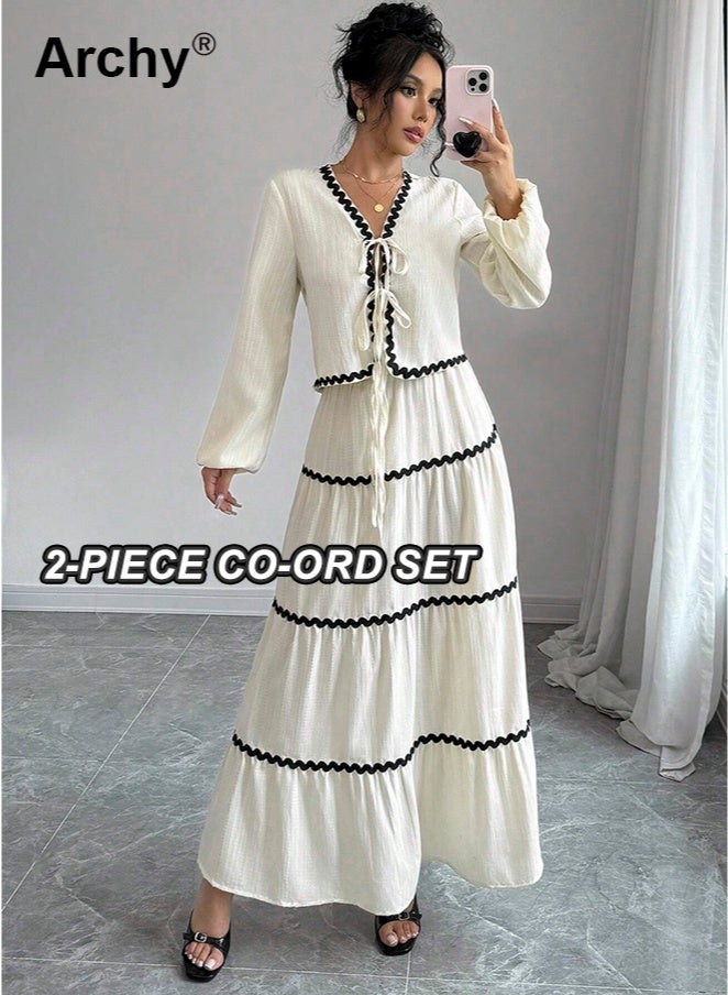 أرشي طقم فستان وتنورة أنيقان على الطراز الفرنسي بأكمام فانوس مكشكشة وعقدة فيونكة، مكون من قطعتين. بلوزة بأكمام فانوس مكشكشة وعقدة فيونكة، وتنورة مطوية متعددة الطبقات | طقم تنسيق أنيق بطابع ريفي وحلو فرنسي. - Image 1