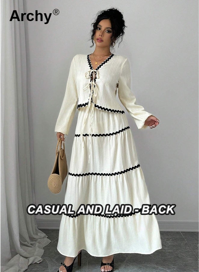 أرشي طقم فستان وتنورة أنيقان على الطراز الفرنسي بأكمام فانوس مكشكشة وعقدة فيونكة، مكون من قطعتين. بلوزة بأكمام فانوس مكشكشة وعقدة فيونكة، وتنورة مطوية متعددة الطبقات | طقم تنسيق أنيق بطابع ريفي وحلو فرنسي. - Image 3