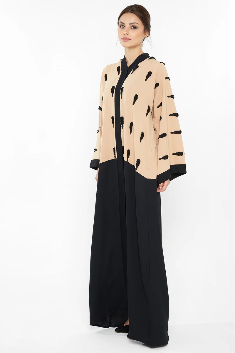 NUKHBAA A casual abaya in cream with black floral embroidery detail-Aj395A