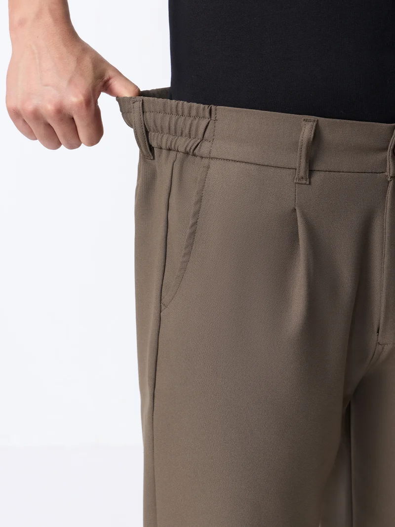 The Souled Store  The Souled Store Super Flex Pants: Men and Boys Sienna Brown Solid Polyester Viscose Elastane Blend Straight Fit Elastic Back Waistband Pleated Front Trousers  | Best Price UAE