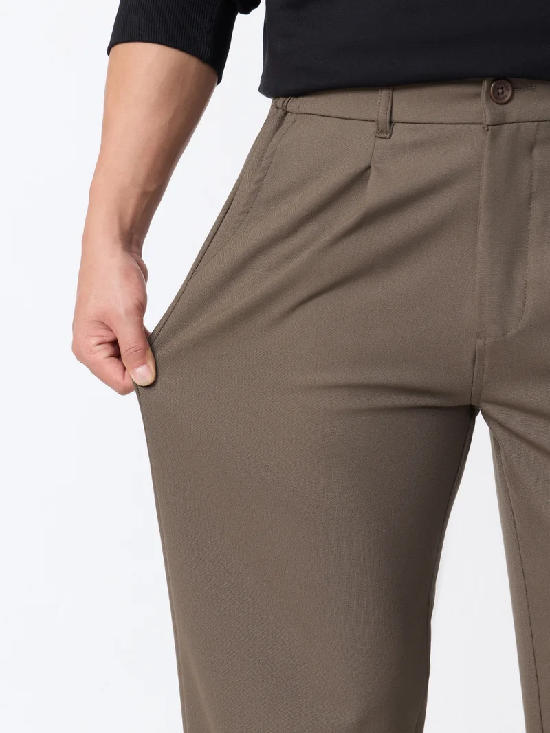 The Souled Store  The Souled Store Super Flex Pants: Men and Boys Sienna Brown Solid Polyester Viscose Elastane Blend Straight Fit Elastic Back Waistband Pleated Front Trousers  | Best Price UAE