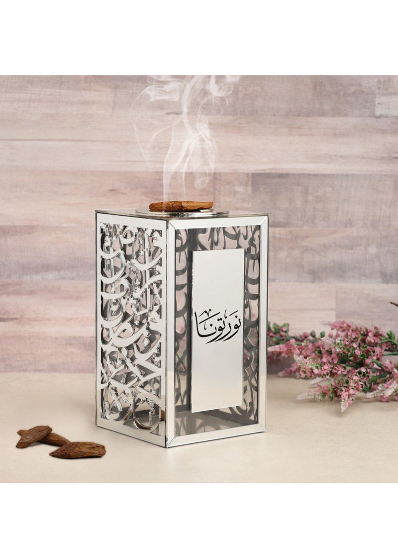 Story Of Candle An Arabic-decorated incense burner made of shiny, transparent acrylic, bearing a distinctive Arabic phrase. - Image 1