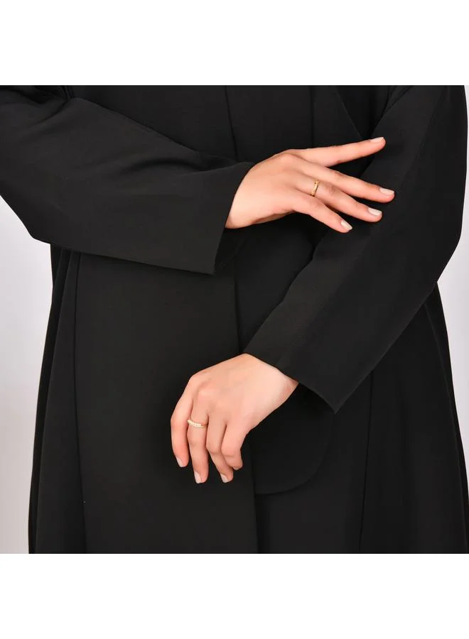 HAWRAA ABAYA Black abaya with formal design and side piece that closes with hidden buttons