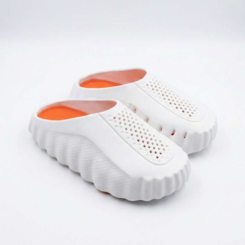 A sleek and comfortable closed-toe slide sandal designed with a unique wave-textured side profile and top ventilation holes, ensuring maximum breathability and cushioned comfort for daily wear.