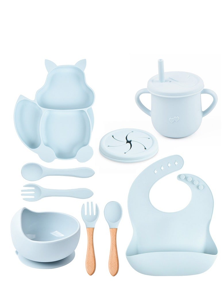 This 8-piece children's silicone tableware set is the perfect solution for safe and efficient baby feeding. Made from high-quality, food-grade silicone, this set is BPA-free, ensuring your child's safety during meals. The set includes a squirrel-shaped silicone plate, bowl, bib, straw cup, silicone spoon and fork, and wooden handle spoon and fork, providing everything your child needs for a complete meal. The cute design and light blue color attract children's attention and make mealtime enjoyable. Easy to clean and dishwasher safe, this set is ideal for both home and travel, promoting independent eating habits in children. - Image 1