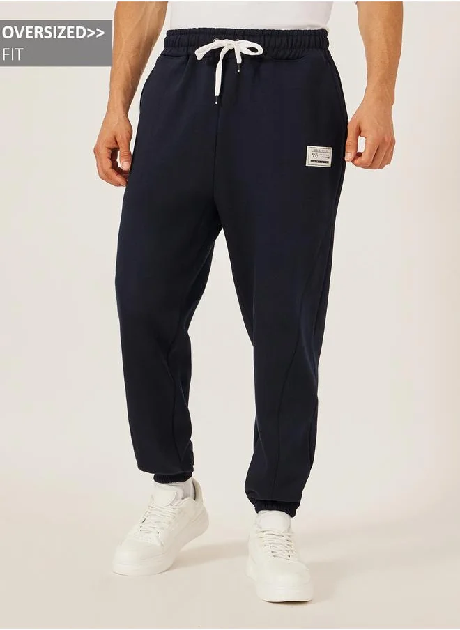 ستايلي Styli Badge Detail Fleece Panelled Joggers with Drawstring