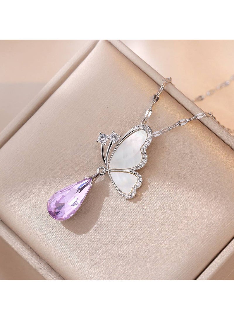 An elegant silver stainless steel necklace with a butterfly design, embellished with a pink teardrop-shaped crystal, sparkling stones, and a silver frame. A delicate piece that adds a touch of femininity and beauty, perfect for adding elegance to your look." 