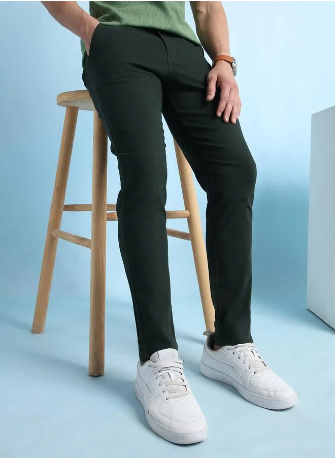 Dennis Lingo Trendy Olive Green Slim Fit Chinos for Men with a solid pattern, mid-rise waist, and a premium cotton-lycra blend for a perfect balance of style and comfort.