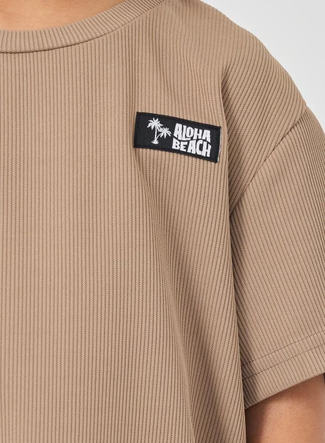 Styli Styli Textured Round Neck T-Shirt with Badge Detail