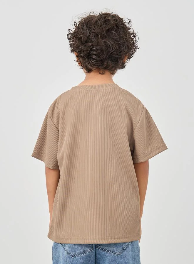 Styli Styli Textured Round Neck T-Shirt with Badge Detail