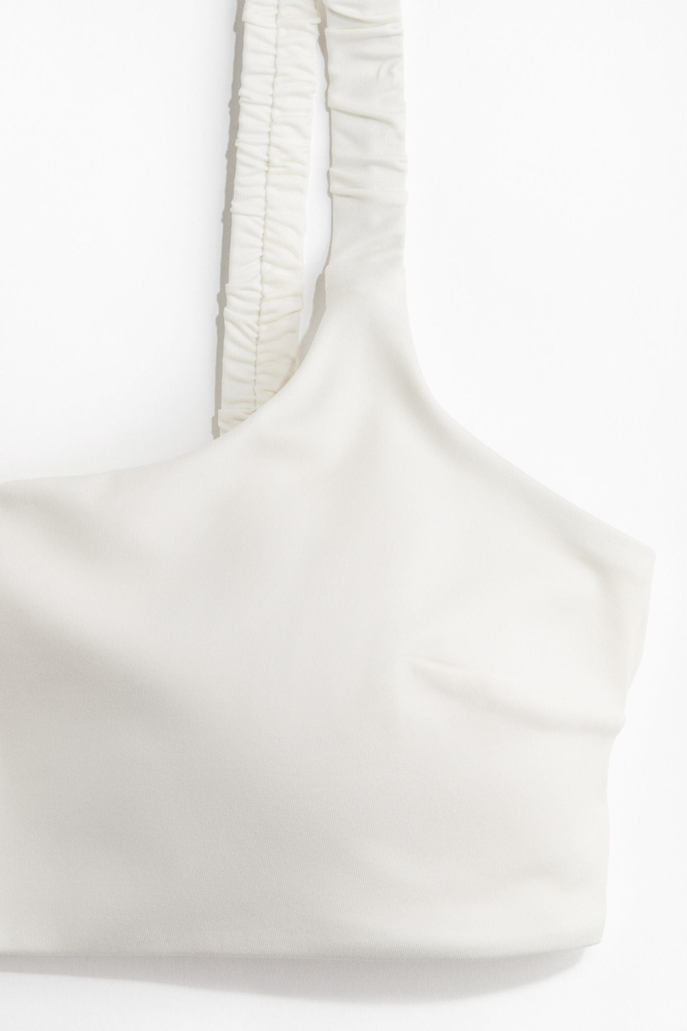 nike one shoulder buckle crop top in off white