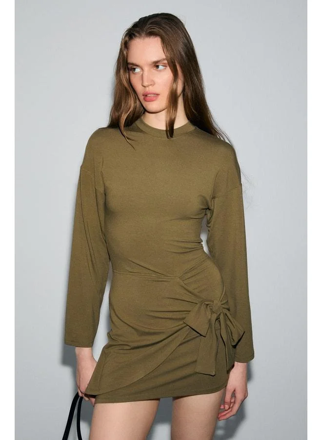 Grimelange SEVLEY Women's Soft and Stretchy Fabric Mini Khaki Dress with Round Neck and Tie Details.
