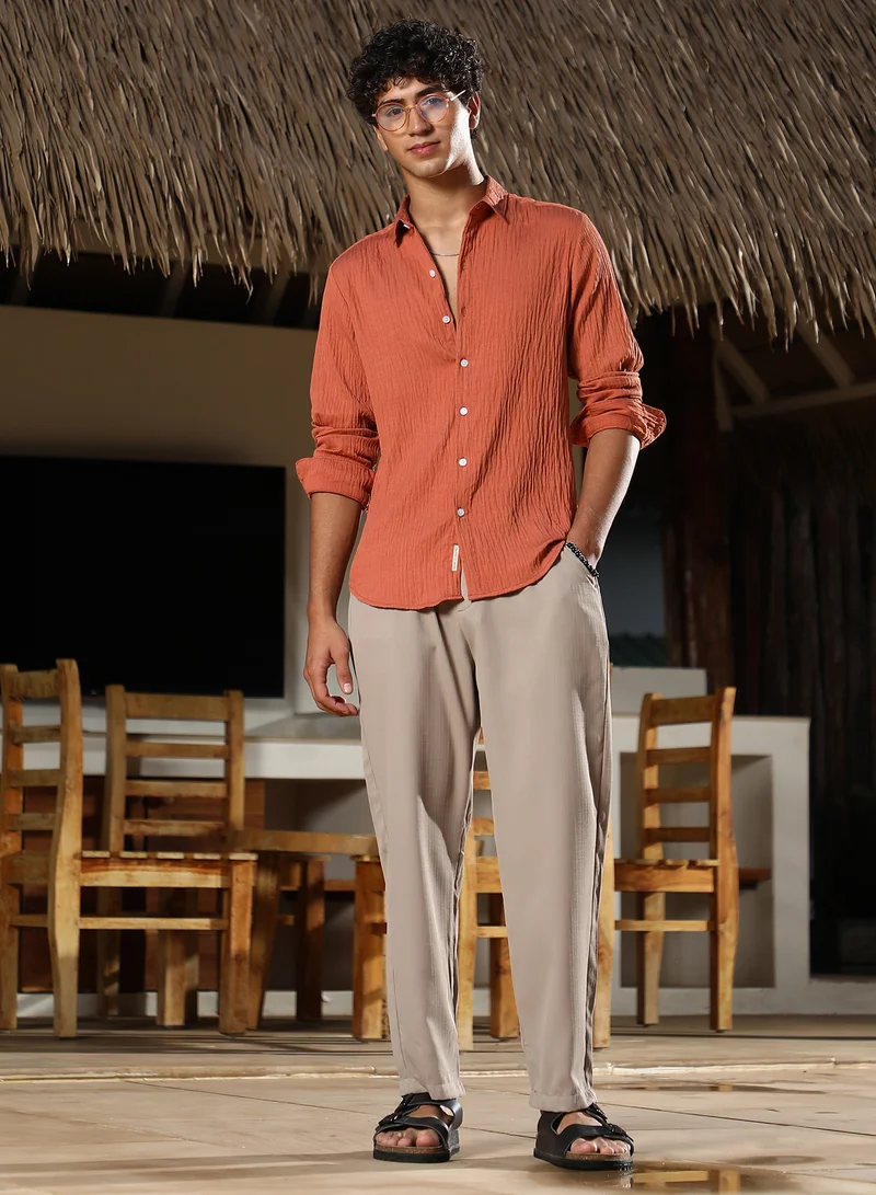 Campus Sutra Campus Sutra Men Solid Creased-Tactile Shirt | Spread Collar Long Cuffed Sleeves | Button Closure Curved Hem | Solid Creased | Woven Fabric For Casual & Daily Wear | Saffron Orange
