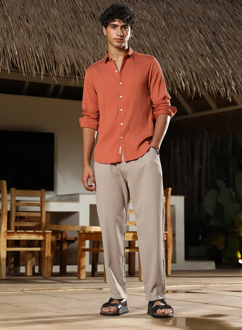 Campus Sutra Campus Sutra Men Solid Creased-Tactile Shirt | Spread Collar Long Cuffed Sleeves | Button Closure Curved Hem | Solid Creased | Woven Fabric For Casual & Daily Wear | Saffron Orange